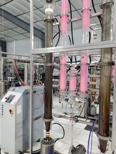 Close up of distillation columns and condensers