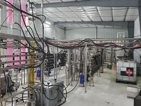 Wiped-film distillation train with heat exchangers